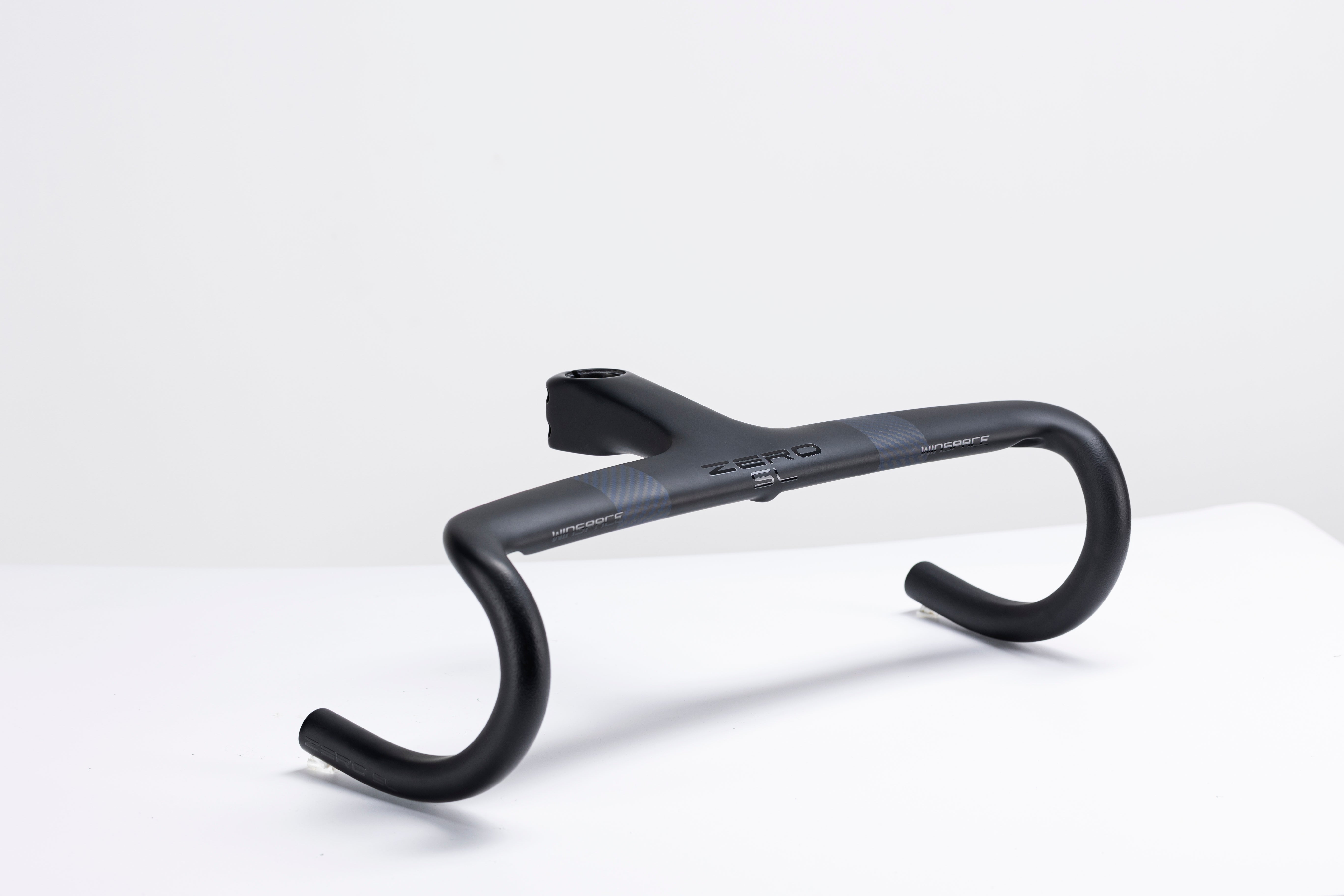 Matte black carbon fiber Zero integrated handlebar with aerodynamic design and checkered pattern detail.